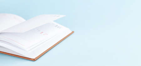 Notepad over blue background with copy space