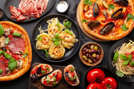 Italian food. Pasta, pizza, olives and antipasto toasts. flat layの写真素材