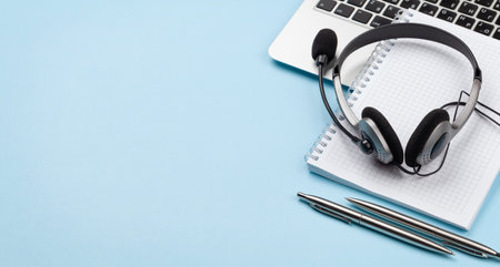 Office desk with headset and laptop. Remote office and work from home concept. With copy space