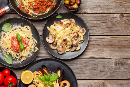 Various Italian pasta. Seafood, mushroom and tomato sauce pasta, spaghetti bolognese. Top view flat lay with copy spaceの写真素材