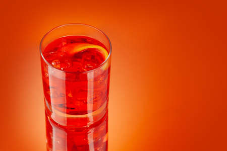 Negroni cocktail on orange background with copy spaceの写真素材
