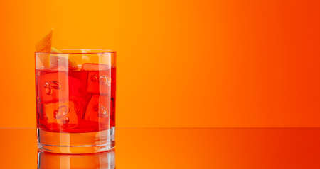 Negroni cocktail on orange background with copy spaceの写真素材