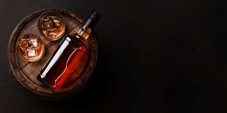 Scotch whiskey bottle, glass and old wooden barrel. With copy space. Top view flat layの写真素材