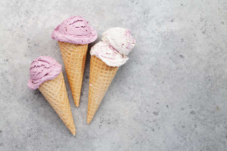 Various ice cream sundae in waffle cones. Top view flat lay with copy space