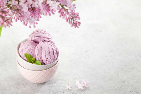 Ice cream sundae bowl and lilac flowers. With copy space