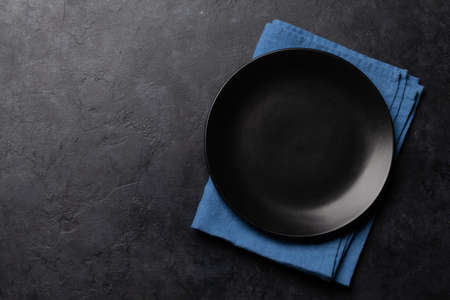 Empty plate and towel on stone table. Top view flat lay with copy space. Template or mockup for your mealsの写真素材