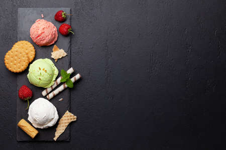 Various ice creams. Strawberry, pistachio and vanilla icecream. Flat lay with copy spaceの写真素材