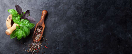Herbs and spices cooking on stone table. Basil, pepper and salt. Top view flat lay with copyspaceの写真素材