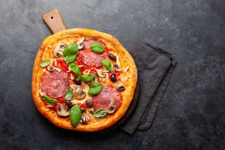 Italian food. Pepperoni pizza. Flat lay on stone table with copy spaceの写真素材