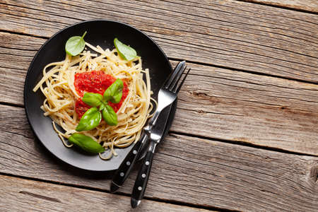 Pasta with tomato sauce and basil. Top view flat lay with copy spaceの写真素材