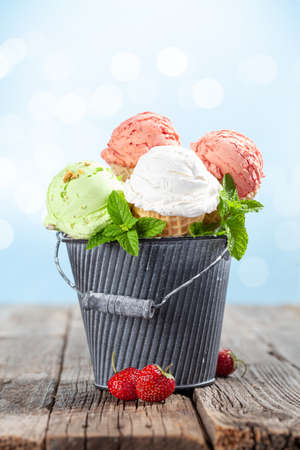 Various ice cream in waffle cones. Strawberry, pistachio and vanilla icecreamの写真素材