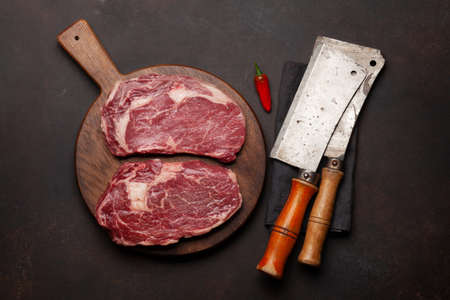 Two raw ribeye beef steaks. Top view flat lay