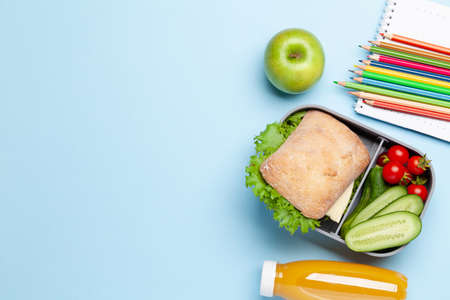 Lunch box with sandwich, vegetables and juice. School or office meal. Flat lay with copy spaceの写真素材