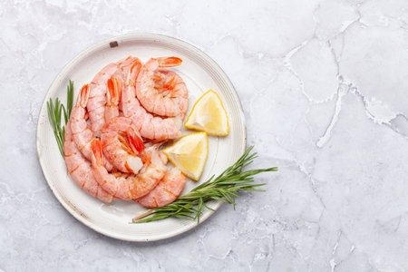 Shrimps on plate with lemon. Flat lay with copy spaceの写真素材