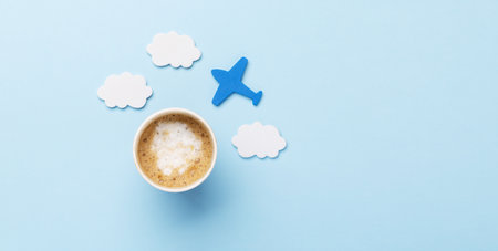 Travel and vacation concept. Coffee and airplane on blue desk with copy spaceの写真素材