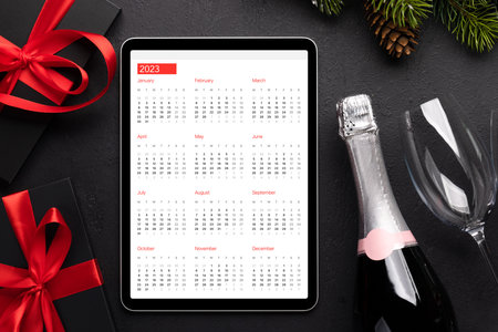Tablet with calendar, gift boxes and Christmas decor. Xmas device screen template