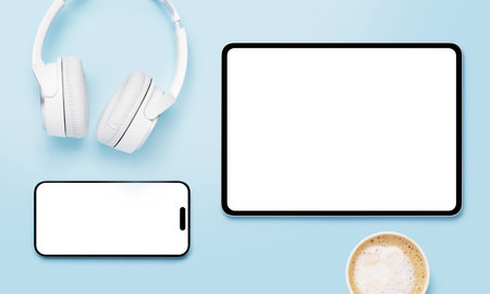 Tablet and smartphone with blank screen on blue background. Flat lay with copy space