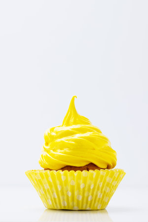 Yellow cupcake on gray background with copy spaceの写真素材