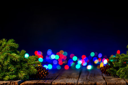 Christmas tree branches with pine cones and garland bokeh. With copy spaceの写真素材