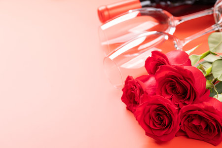 Valentines day card with wine, rose flowers and gift box. On red background with space for your greetingsの写真素材