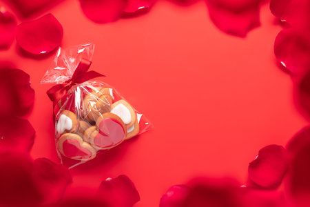 Valentines day heart shaped cookies on red background. Flat lay with copy spaceの写真素材