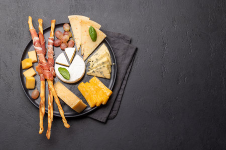 Antipasto board with various cheese and snacks. Flat lay with copy space