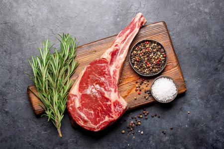 Raw Tomahawk beef steak and spices. Ready for grilling. flat layの写真素材