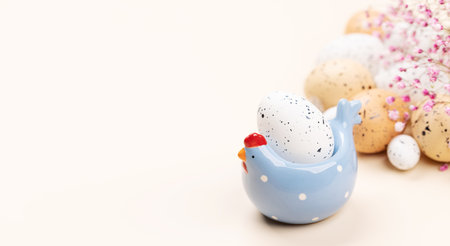 Easter eggs in chicken decor over beige background. With copy spaceの写真素材