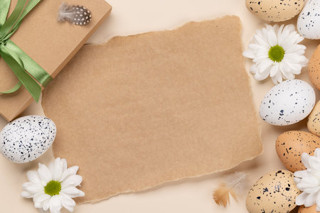Gift box, Easter eggs and flowers on a beige background with space for your greetings. flat layの写真素材