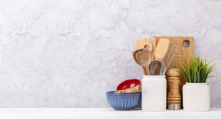 Kitchen utensils on wooden table. Front view with copy space