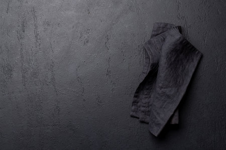 Empty dark stone table with black napkin. Flat lay with copy spaceの写真素材