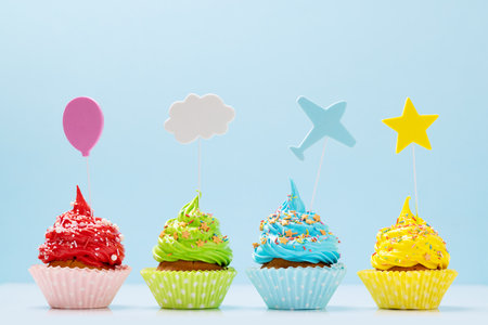 Colorful cupcakes on blue background with copy spaceの写真素材