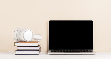 Laptop with blank screen for your message, app or web and headphones. computer with white displayの写真素材