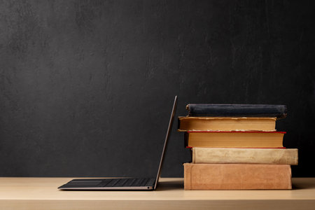 Laptop and stack of old books. With space for your text. Learn and work conceptの写真素材