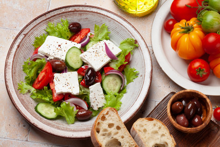 Greek salad with fresh vegetables and feta cheese. flat layの写真素材