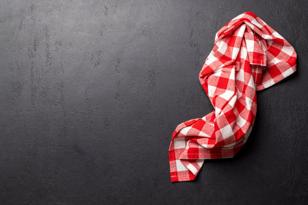 Top-down view of a kitchen table with a towel or napkin, creating a mockup perfect for meal presentation and creating a menu or recipe templateの写真素材