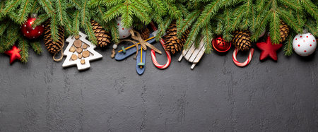 Christmas fir tree branch with decor and space for greetings text. flat lay