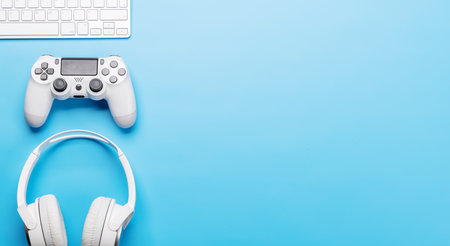 Gaming gear and tech accessories on a blue background, perfect for gaming and tech-related themes. Flat lay with copy spaceの写真素材