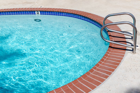 Poolside and blue water of pool. With copy space