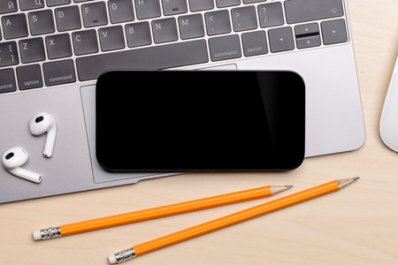 Blank black screen smartphone on a desk, perfect for your design mockupの写真素材
