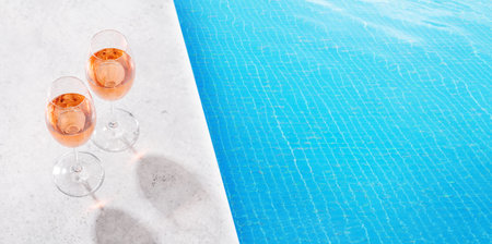 Refreshing rose wine by the pool on a sunny day, the perfect summer vacation. With space for your textの写真素材