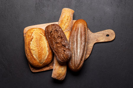 Fresh baked bread on cutting board. Flat lay with
