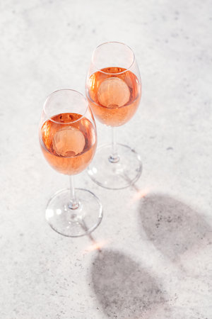 Refreshing rose wine by the pool on a sunny day, the perfect summer vacation. View from above with space for your textの写真素材