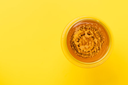 A cold beer on a bright yellow background with copy space. flat layの写真素材