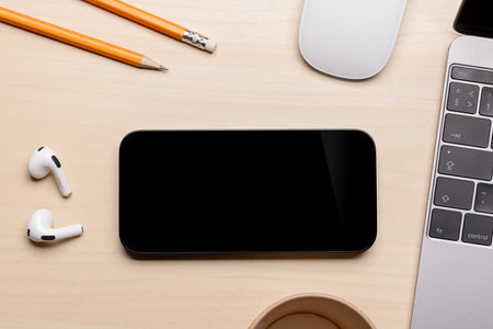 Blank black screen smartphone on a desk, perfect for your design mockupの写真素材