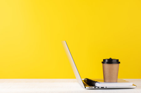 Laptop, notepad and coffee cup. Computer on desk with blank space for your textの写真素材