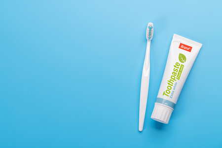 A clean and refreshing image featuring toothpaste and toothbrush, promoting oral hygiene and a bright smile. Flat lay with copy spaceの写真素材