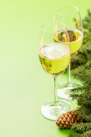 Christmas fir tree branch, champagne and space for xmas greetings textの写真素材