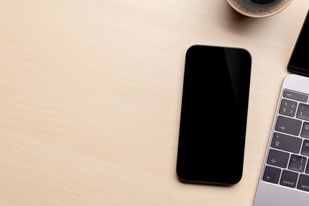 Blank black screen smartphone on a desk, perfect for your design mockupの写真素材