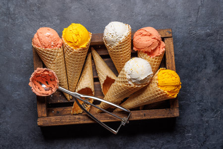 Assorted ice cream flavors in delightful waffle cones, a treat for every taste bud. Over stone...